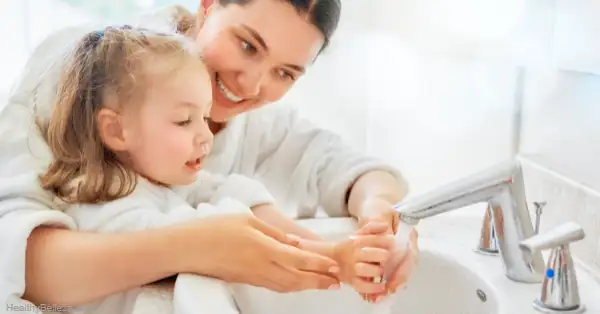 Girl washing her hands correctly and efficiently using soap