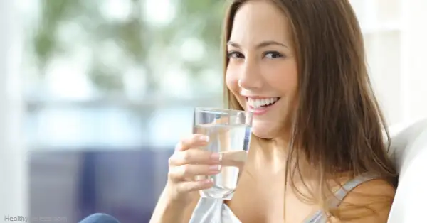 Woman drinking Potable water obtained with homemade treatment